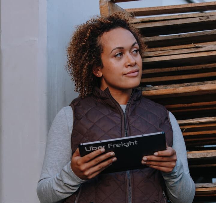 Employee waiting for shipment on loading dock with ipad
